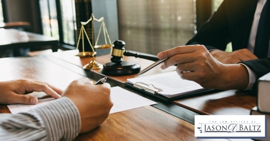 Hands of an attorney and man going over documentation