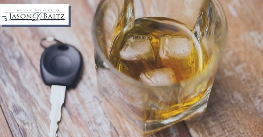 car key and glass of whiskey