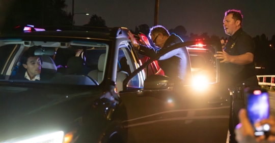 police officer arresting an individual for drunk driving